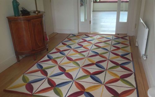 Hand tufted rug with colourful leaf and squares pattern