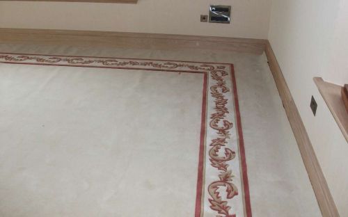 Hand tufted cream carpet with floral border