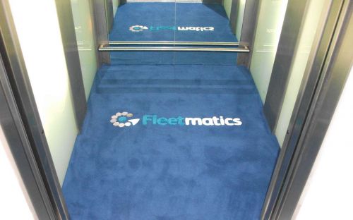 Hand tufted elevator carpet with Fleetmatics company logo