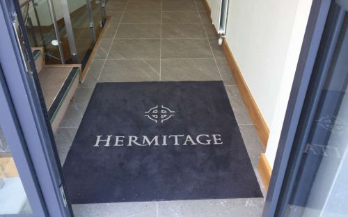 Hand tufted entrance rug with logo