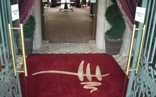 Hand tufted inset carpet with logo