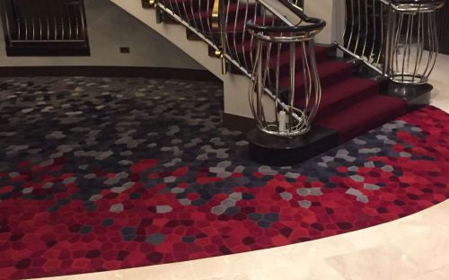 Hand tufted inset carpet with red and grey honey comb shapes - Red cow hotel