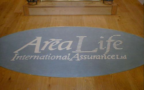 Hand tufted inset rug with area life company logo