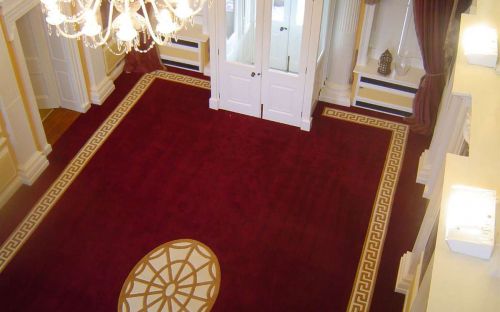Hand tufted Red hallway carpet with gold greek key border and motif
