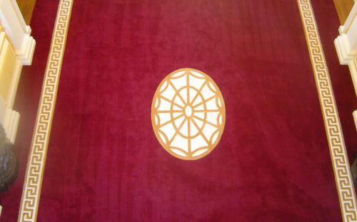 Hand tufted Red hallway carpet with gold greek key border and motif