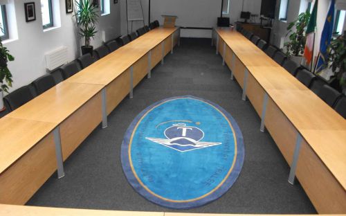 Hand tufted rug with company logo in boardroom