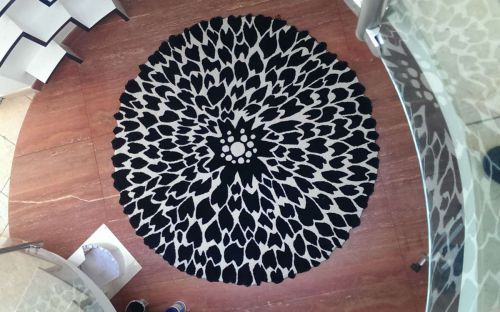 Hand tufted white circle rug with black print